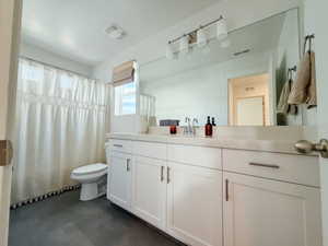 Bathroom featuring a shower with curtain and vanity
