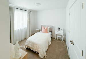 Bedroom with carpet floors and baseboards