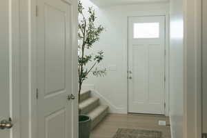 Entrance foyer featuring light wood-type flooring and stairway