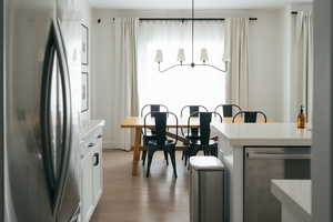 Dining space with light wood-style floors