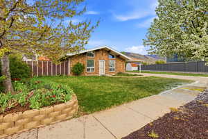 Mid-century home featuring brick siding and a mountain view