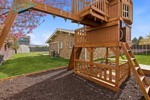 Fenced backyard with a storage shed and a deck