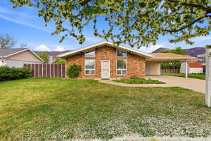View of front of property with a carport, concrete driveway, brick siding, and a mountain view