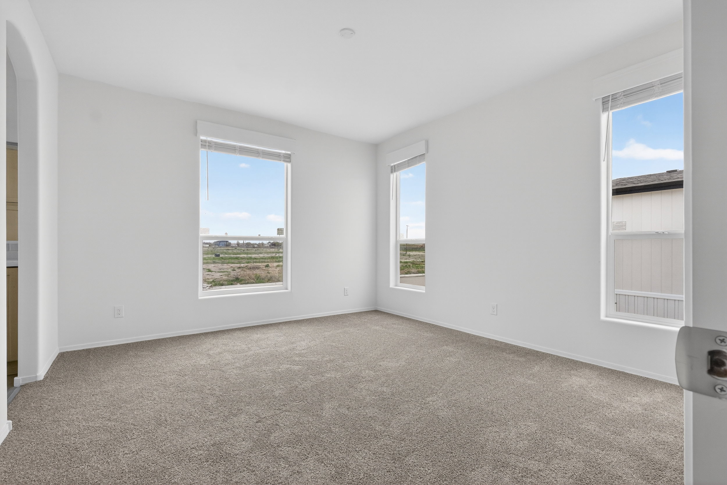 Carpeted empty room featuring baseboards