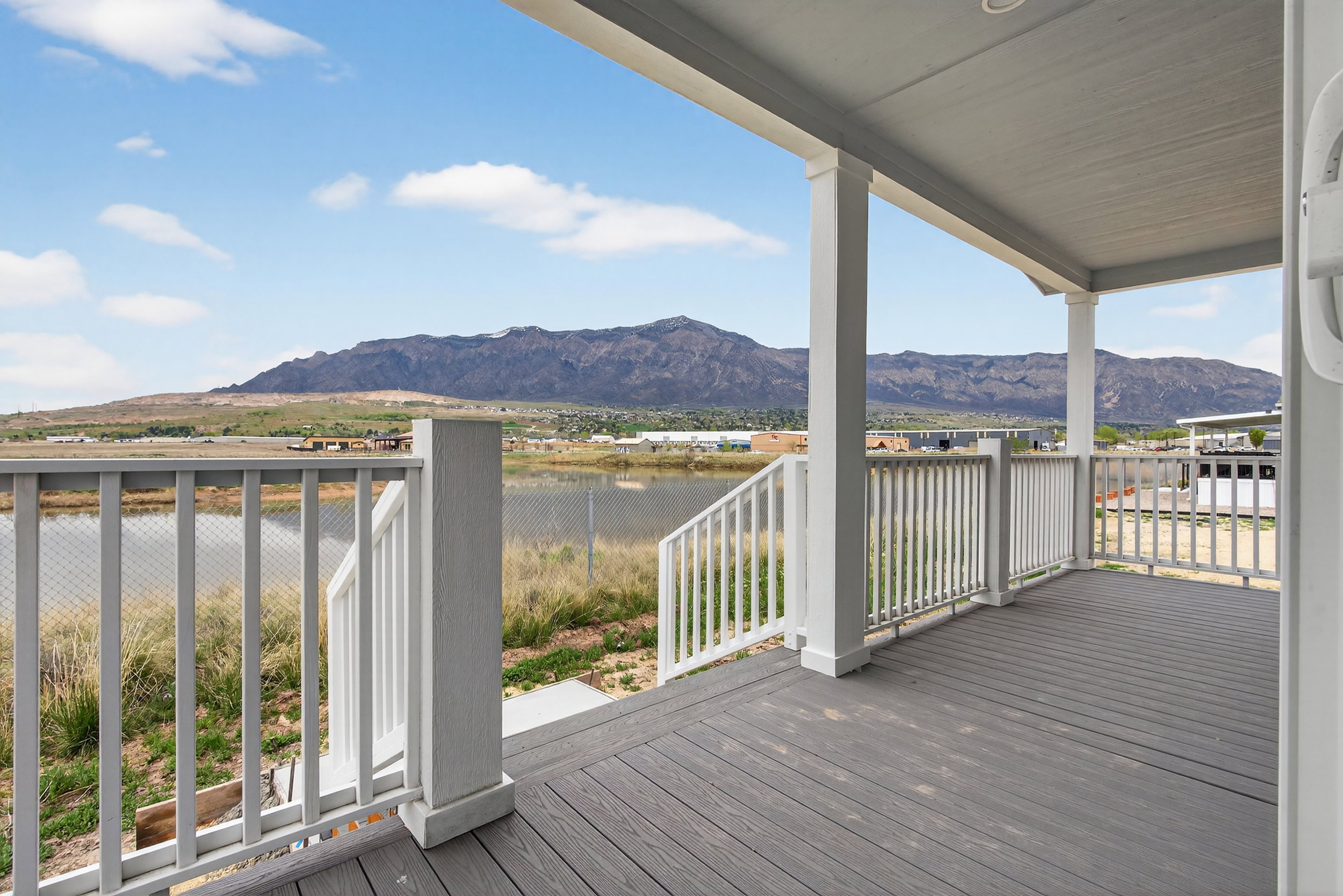 Deck with a water and mountain view