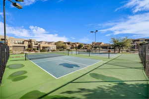 View of tennis court featuring a residential view
