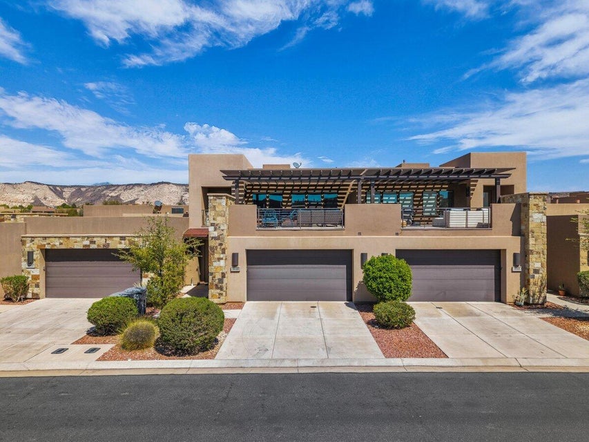 View of front of property featuring stucco siding, driveway, and a mountain view