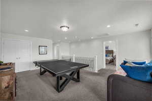 Rec room featuring carpet floors, a textured ceiling, and recessed lighting