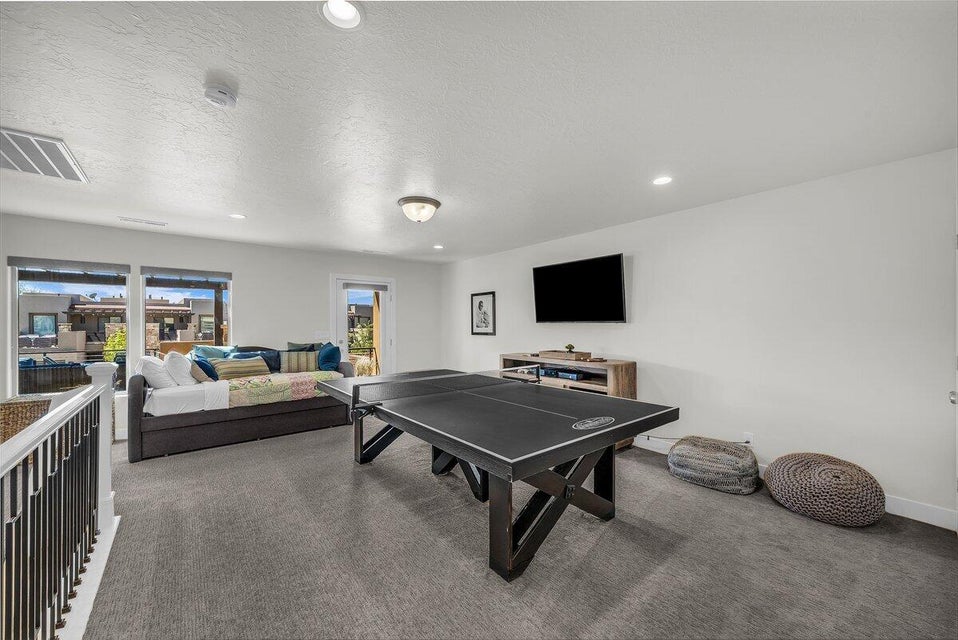 Playroom with a textured ceiling, carpet flooring, and recessed lighting