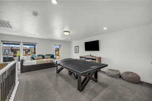 Playroom with a textured ceiling, carpet flooring, and recessed lighting