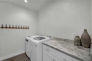Laundry area featuring washer and clothes dryer, dark wood-style floors, cabinet space, and recessed lighting