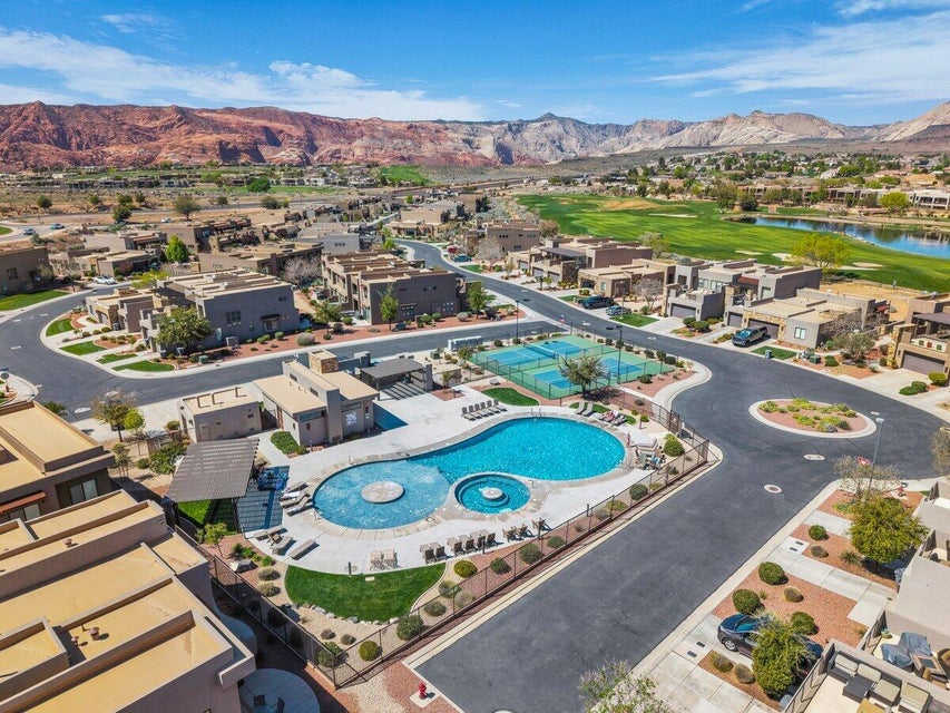 Aerial perspective of suburban area with a pool and a water and mountain view