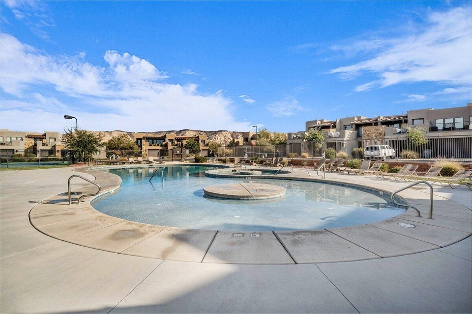 Community pool featuring a residential view, a patio, and a community hot tub