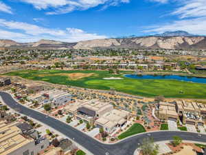 Aerial perspective of suburban area featuring a golf club and a water and mountain view