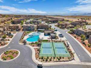 Aerial perspective of suburban area with a pool and a mountainous background