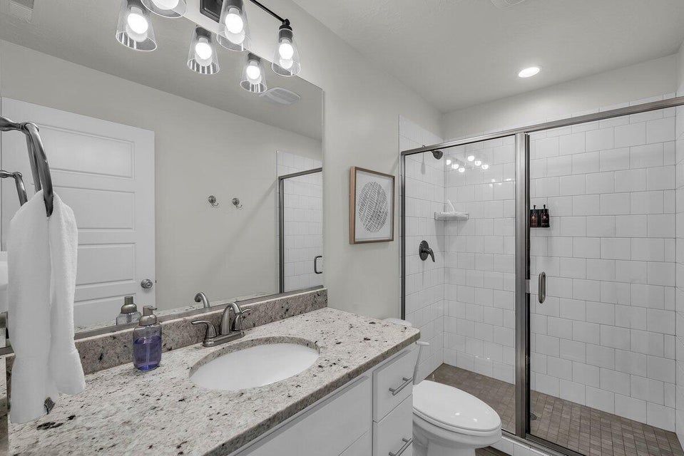 Full bath featuring vanity and a shower stall