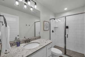 Full bath featuring vanity and a shower stall