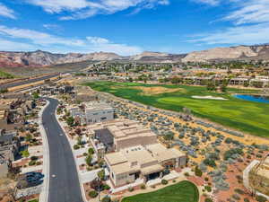 Aerial perspective of suburban area featuring a local golf course and a water and mountain view
