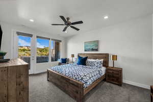Bedroom with access to exterior, dark colored carpet, ceiling fan, a textured ceiling, and recessed lighting