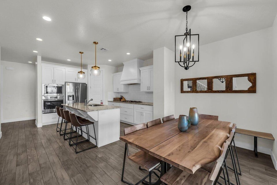 Dining area featuring dark wood finished floors and suspended lighting