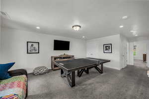 Rec room with carpet flooring, a textured ceiling, and recessed lighting
