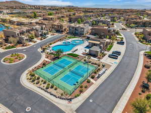 Aerial perspective of suburban area with a pool area and mountains