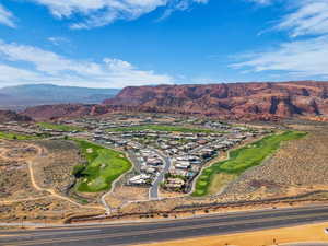 View of mountain backdrop with a golf course and nearby suburban area