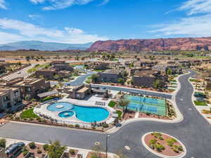 Aerial perspective of suburban area featuring mountains and a pool