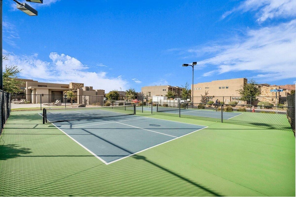 View of tennis court featuring a residential view