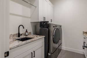 Laundry area with independent washer and dryer and cabinet space