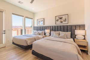Bedroom featuring light wood-style flooring, a ceiling fan, recessed lighting, and a mountain view