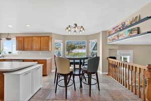 Dining area featuring suspended lighting and stone tile floors