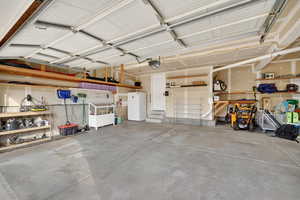 Garage featuring freestanding refrigerator