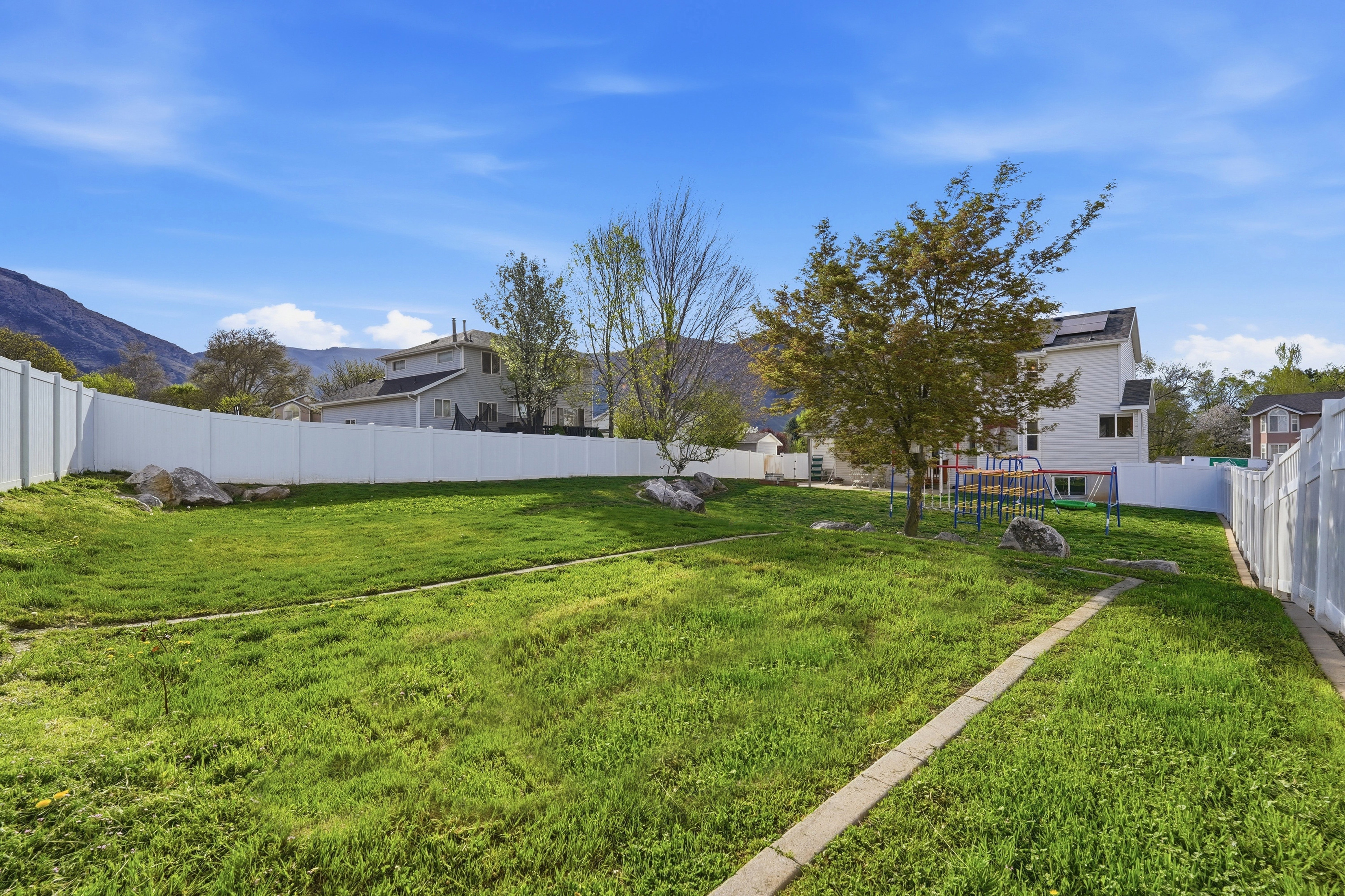 Fenced backyard featuring a mountain view