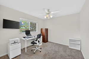 Office area featuring carpet flooring and ceiling fan