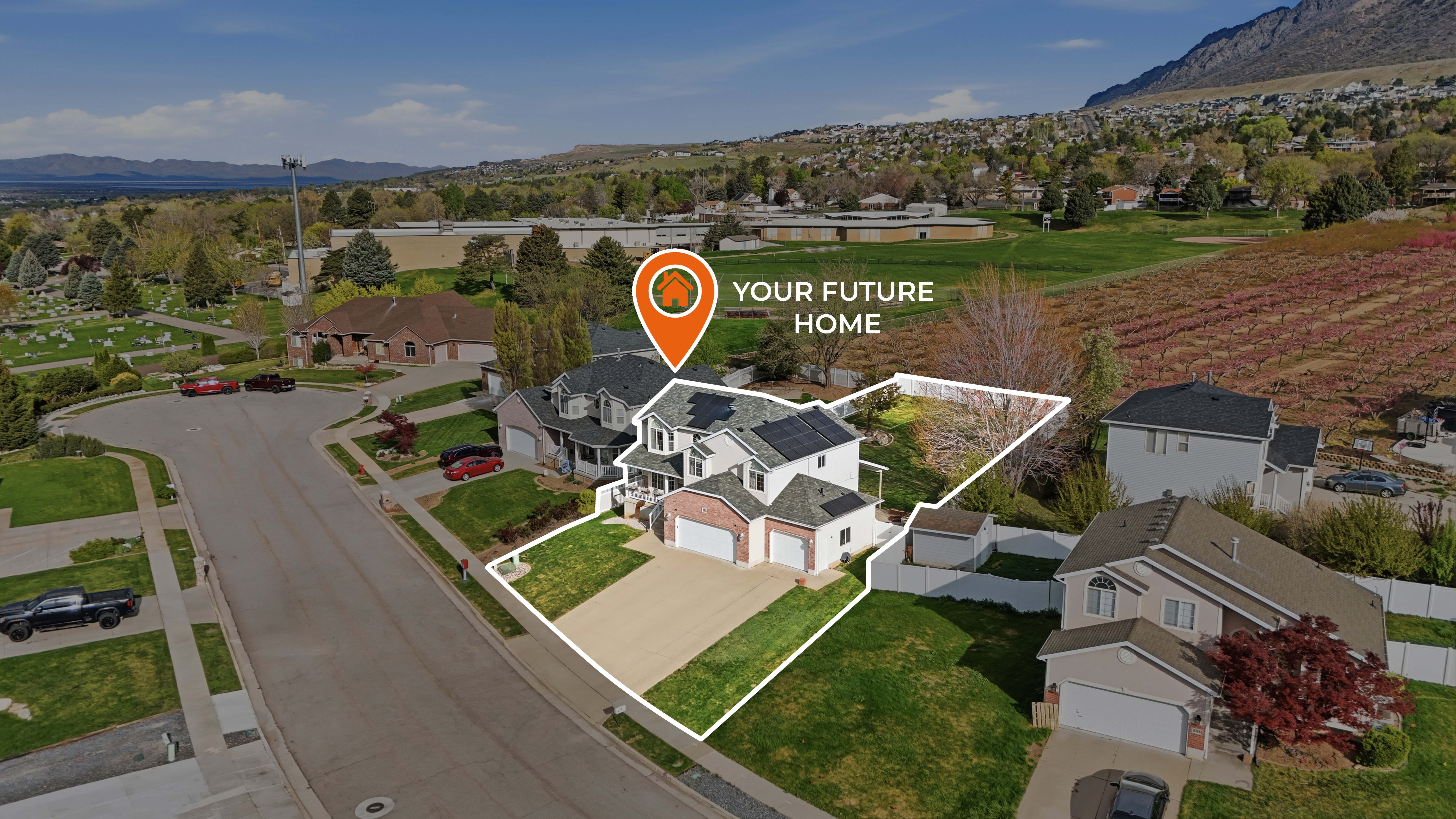Aerial perspective of suburban area with property boundaries highlighted and a mountainous background