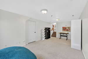 Bedroom with light carpet and baseboards