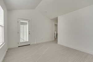 Spare room featuring light colored carpet and baseboards