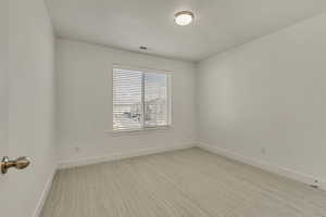 Empty room featuring light carpet and baseboards