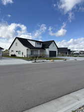 Modern farmhouse featuring board and batten siding, a garage, and covered porch