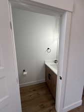 Bathroom with dark wood finished floors and vanity