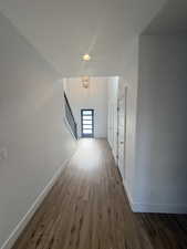 Corridor featuring dark wood-style floors and recessed lighting