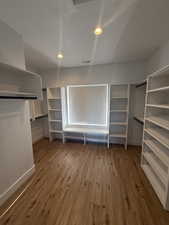 Walk in closet featuring light wood-style floors