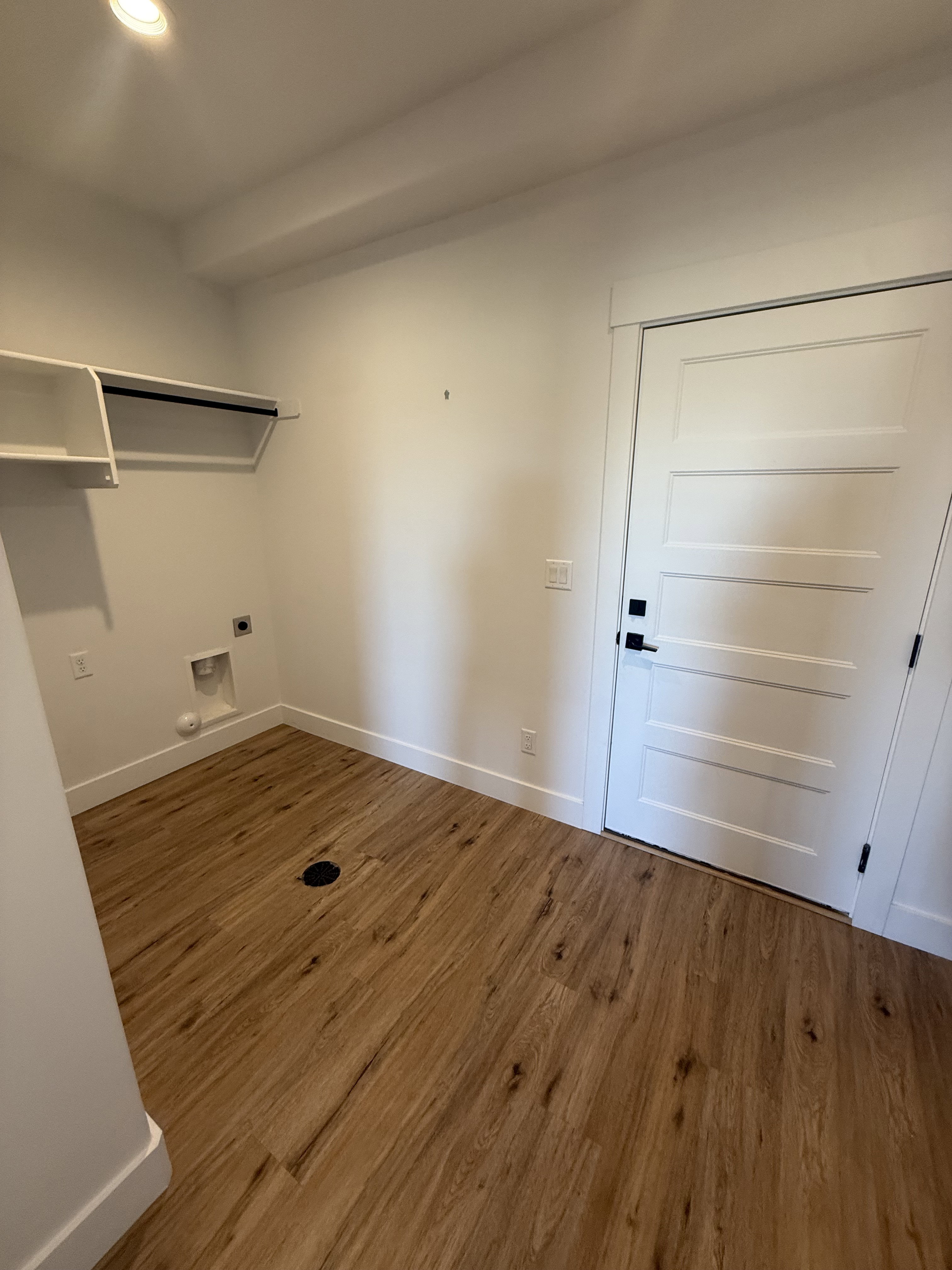 Laundry area with dark wood-style floors, recessed lighting, and electric dryer hookup