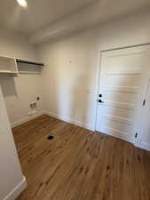 Laundry area with dark wood-style floors, recessed lighting, and electric dryer hookup