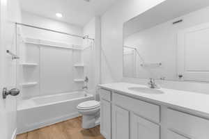Bathroom with light wood-style floors, vanity, and bathtub / shower combination
