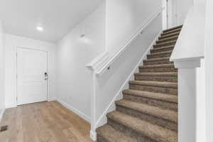 Foyer entrance featuring stairway and light wood-style flooring