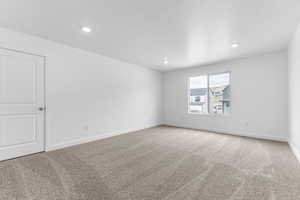 Unfurnished room featuring light colored carpet, recessed lighting, and a textured ceiling