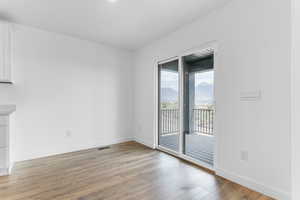 Unfurnished room featuring light wood finished floors and a mountain view
