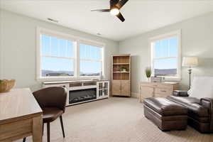 Sitting room with ceiling fan, light carpet, and a mountain view, walk in closet